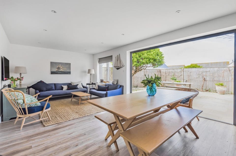 Open plan sitting and dining area with bi-fold doors to patio garden