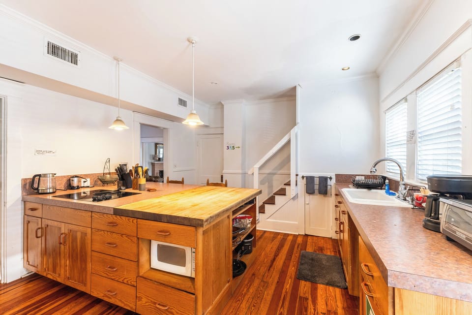 Huge central island with a built-in cooktop and a butcher-block prep station.
