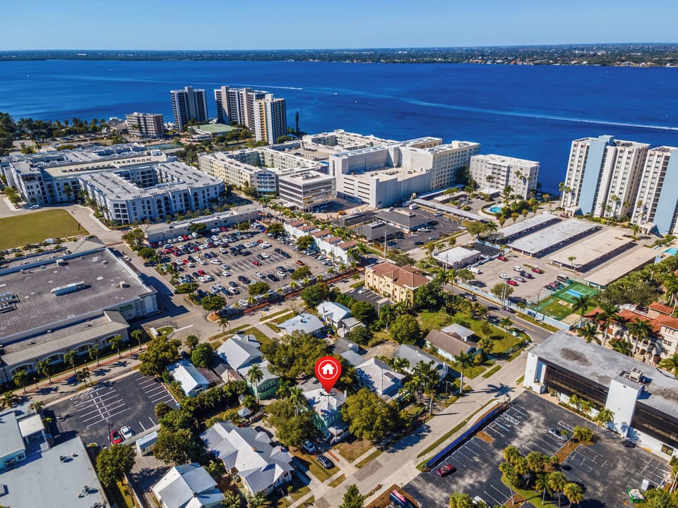 Panoramic view showing the neighborhood, parking, and close proximity to shops.