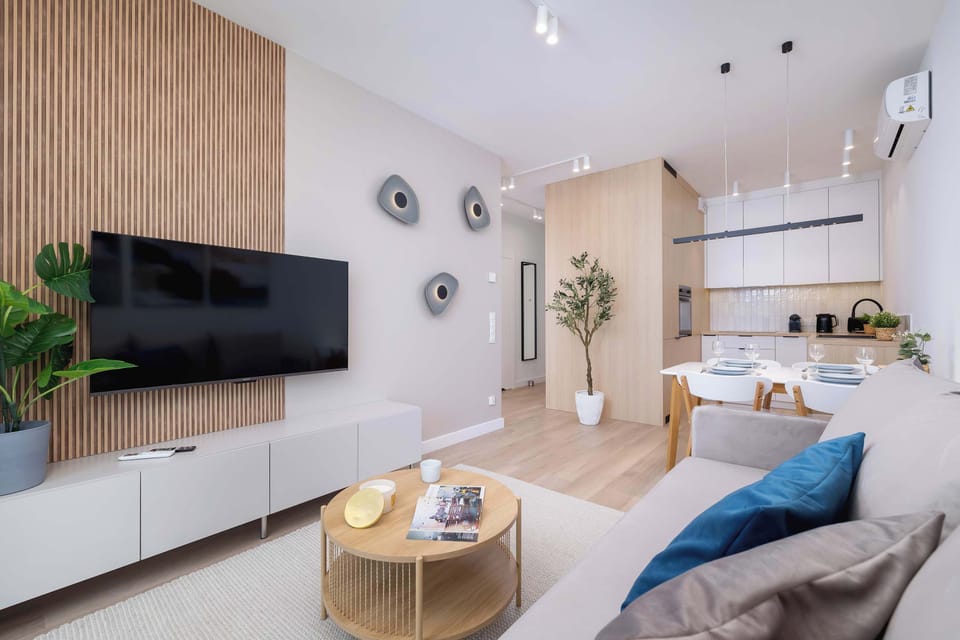 The living room with a designer wall and TV offers the perfect setup for evening relaxation.

