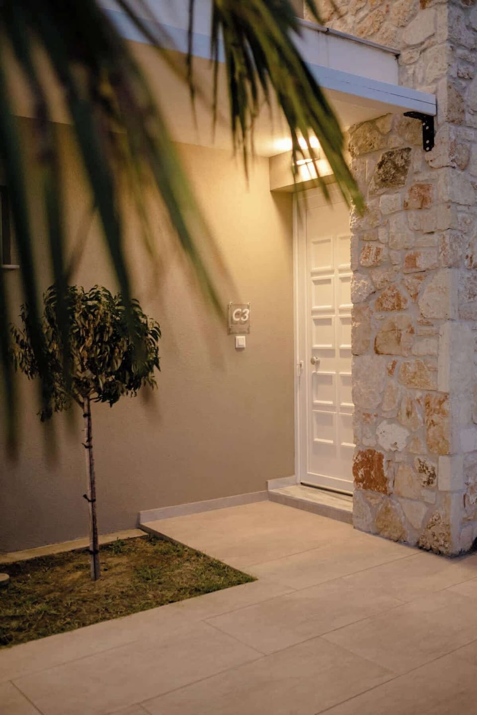 Charming outdoor entrance surrounded by tropical-inspired details.