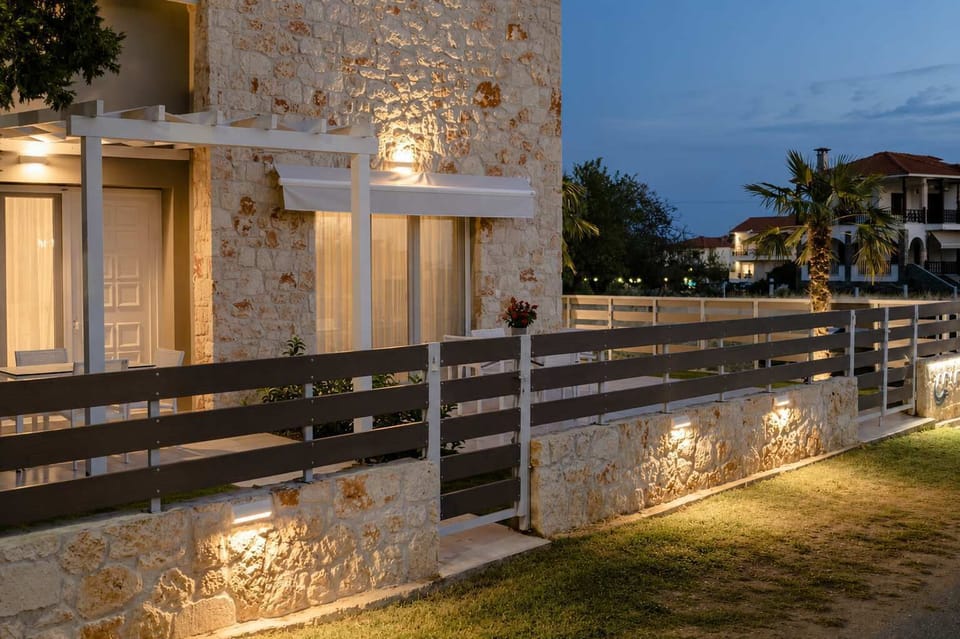 Elegant stone building glowing at sunset with private entrance and ambient lighting