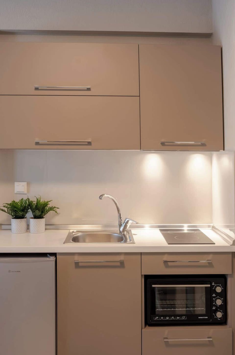 Contemporary kitchenette with modern appliances and sleek finishes