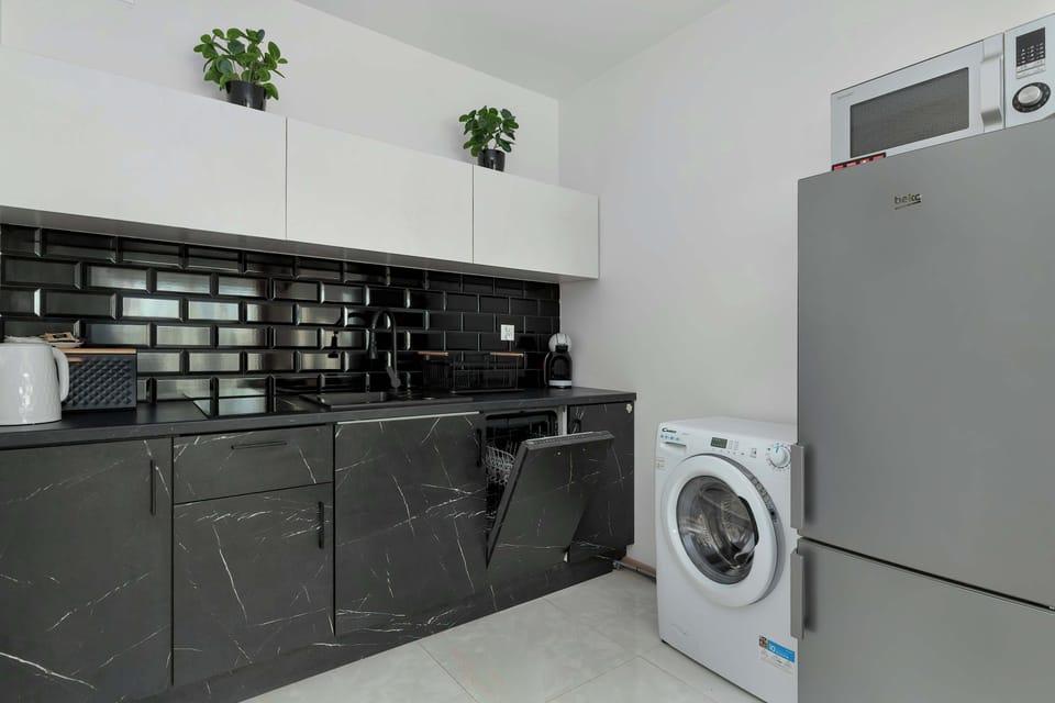 The sleek design of the kitchenette blending seamlessly with the living area.