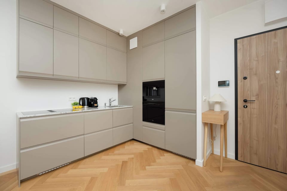 The sleek design of the kitchenette blending seamlessly with the living area.