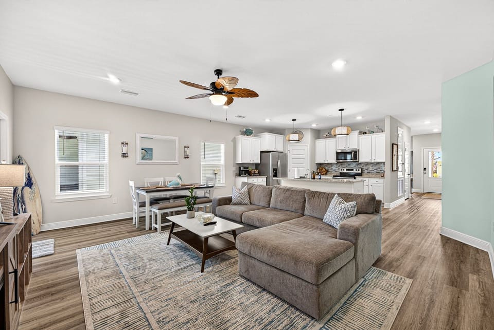 Bright open-concept living space with large sectional and modern kitchen