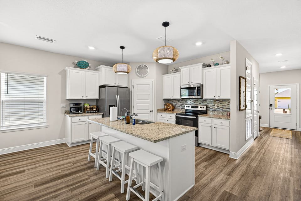 Bright gourmet kitchen with granite island seating for 4