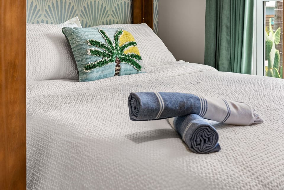 Bedroom 3: Bright, coastal-inspired bedroom with crisp linens and tropical touch