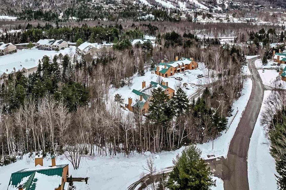 Winter aerial view of the home, nestled in the heart of Bretton Woods, with the ski area in the background