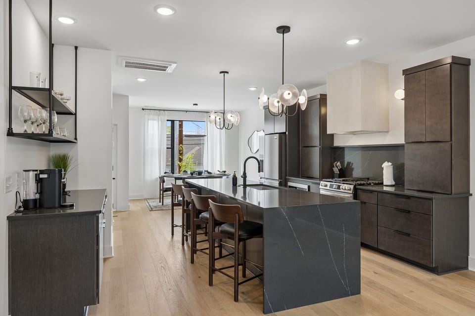 Kitchen: A stylish kitchen with an island, bar seating, and contemporary lighting.