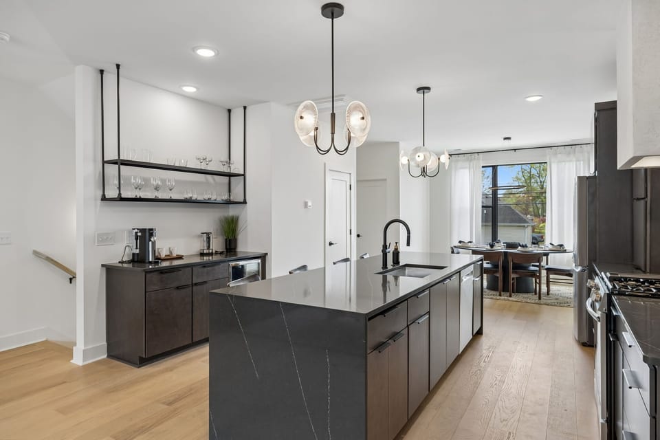 Kitchen: A stylish kitchen with an island, bar seating, and contemporary lighting.