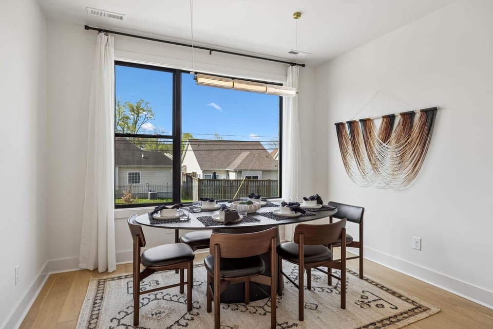Dining Area: A stylish dining room with a wooden table, upholstered chairs, and a modern chandelier.