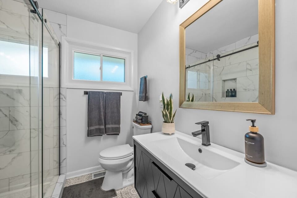 Walk-in shower and polished bath finishes add elegance to the stay.