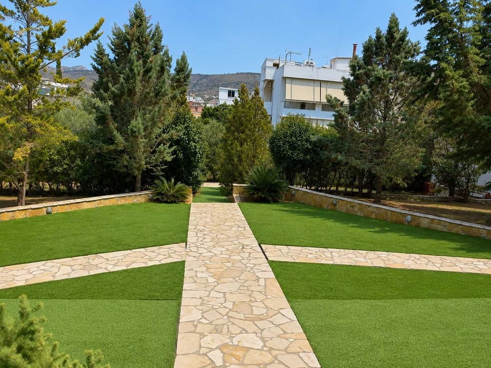 Shared outdoor garden area with landscaped paths and seating space, creating a calm environment for morning coffee or relaxing after visiting nearby beaches.