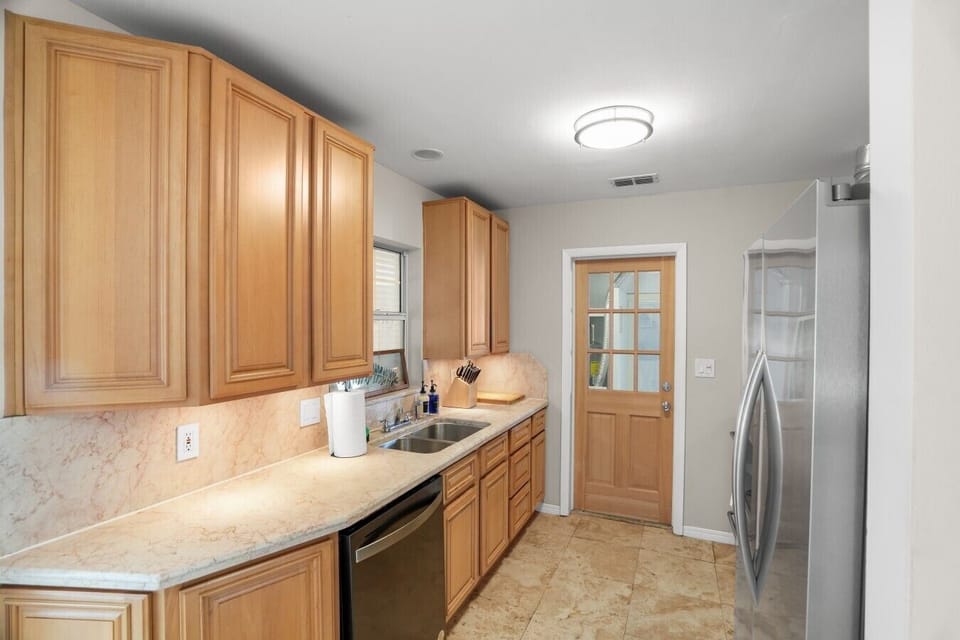 View of updated kitchen with access to garage and ping pong table