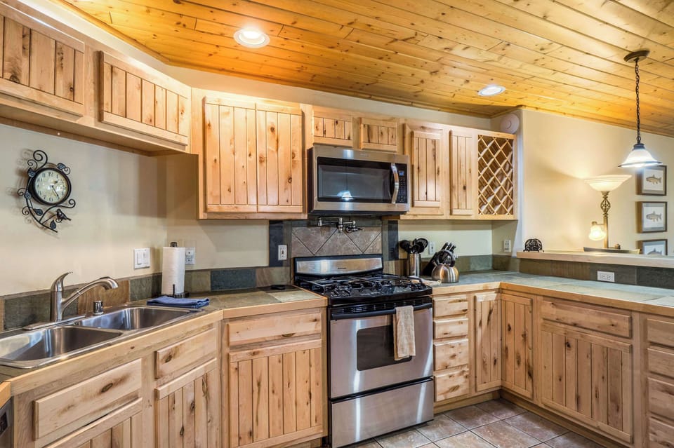 Cook on the gas range with a double sink and full counter space