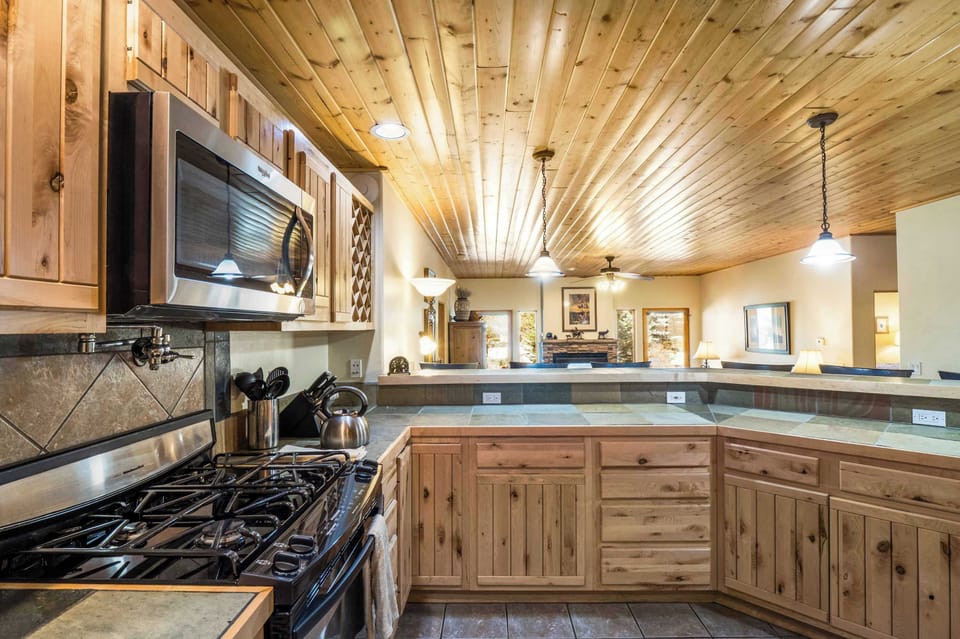 The open kitchen looks straight through to the fireside living room