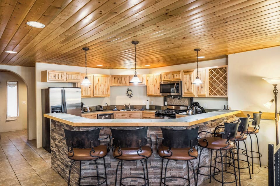 Pull up a barstool at the stacked-stone breakfast bar