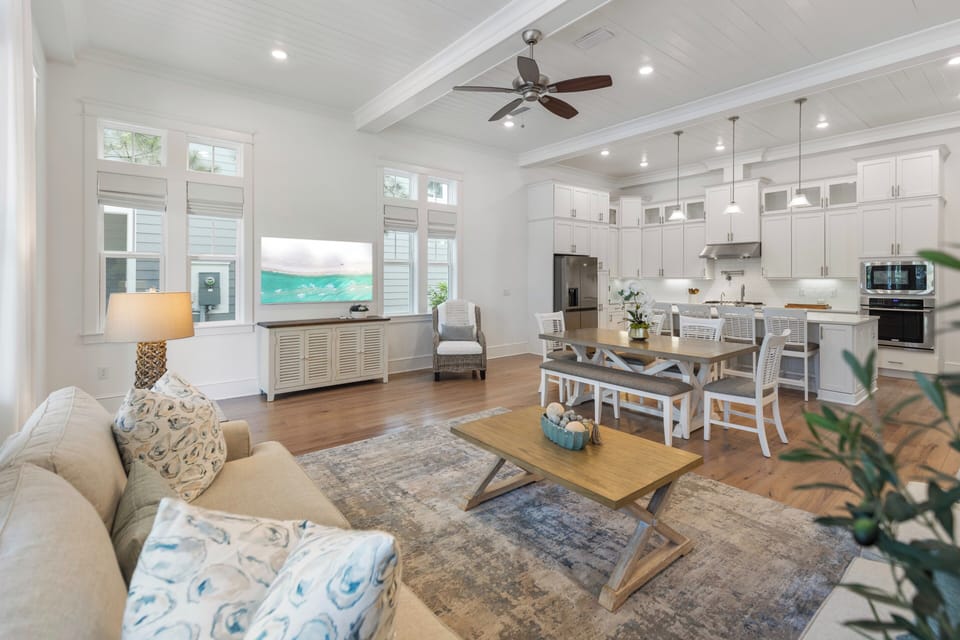 Step into your bright, open living space where coastal charm meets modern comfort. High ceilings, gleaming wood floors, and a fully-equipped kitchen invite you to unwind and gather with loved ones.
