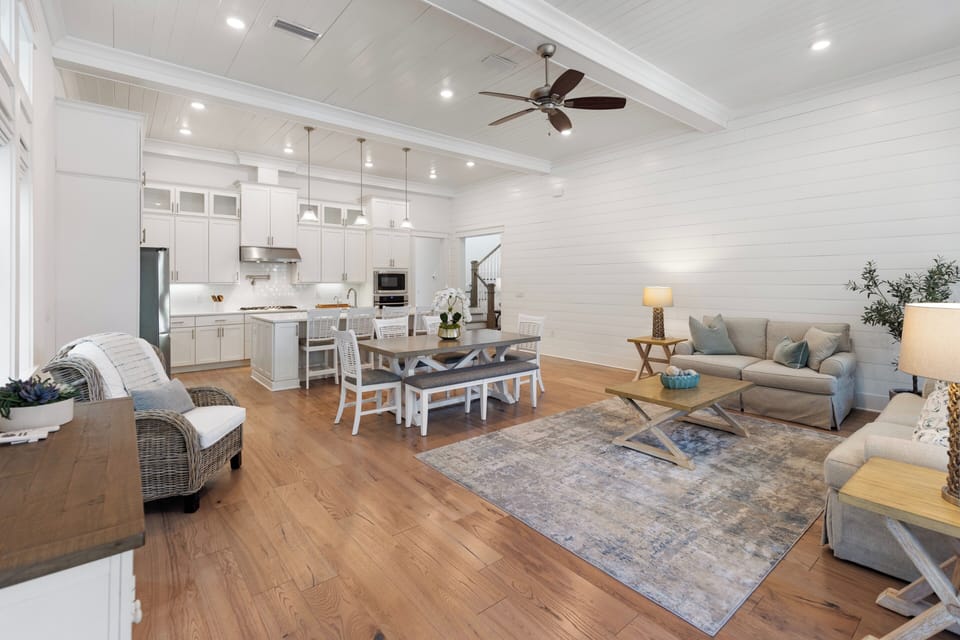 Bright open-concept living blends your kitchen, dining, and lounge into one inviting space where you can cook, gather, and unwind together beneath soaring ceilings and warm wood floors.