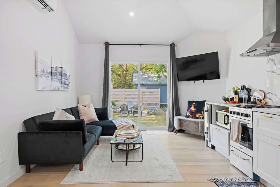 The bright open living area with vaulted ceilings makes this cozy cottage feel grand.