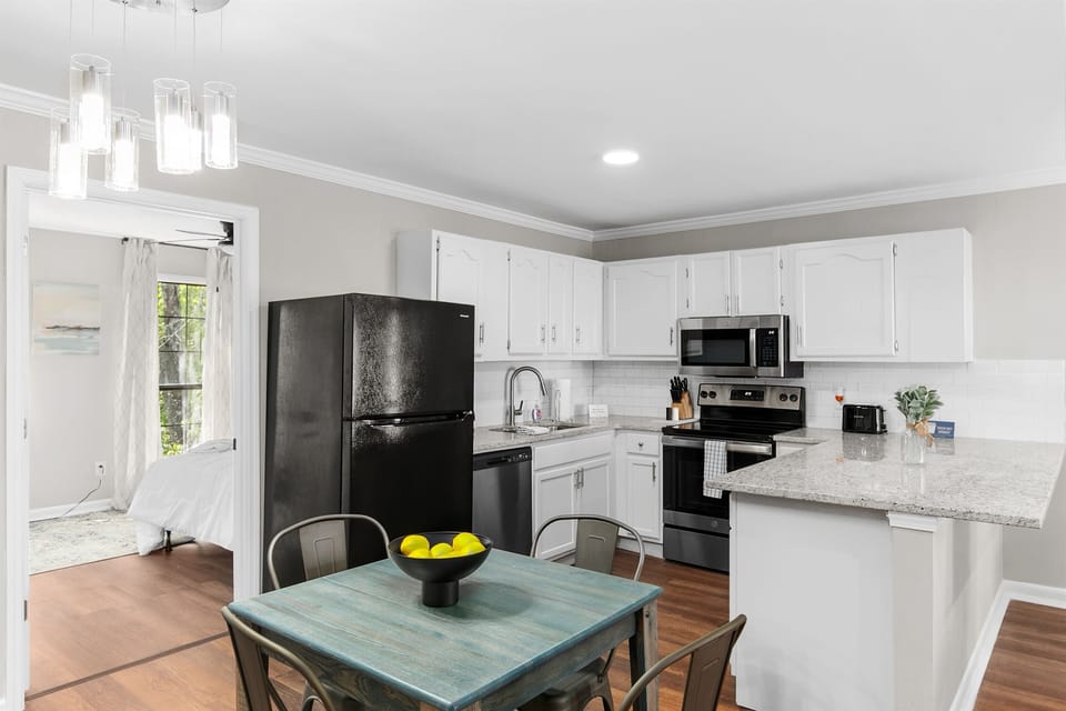 The kitchen opens right up to the dining area, keeping everything connected and making it easy to cook, serve, and gather together.