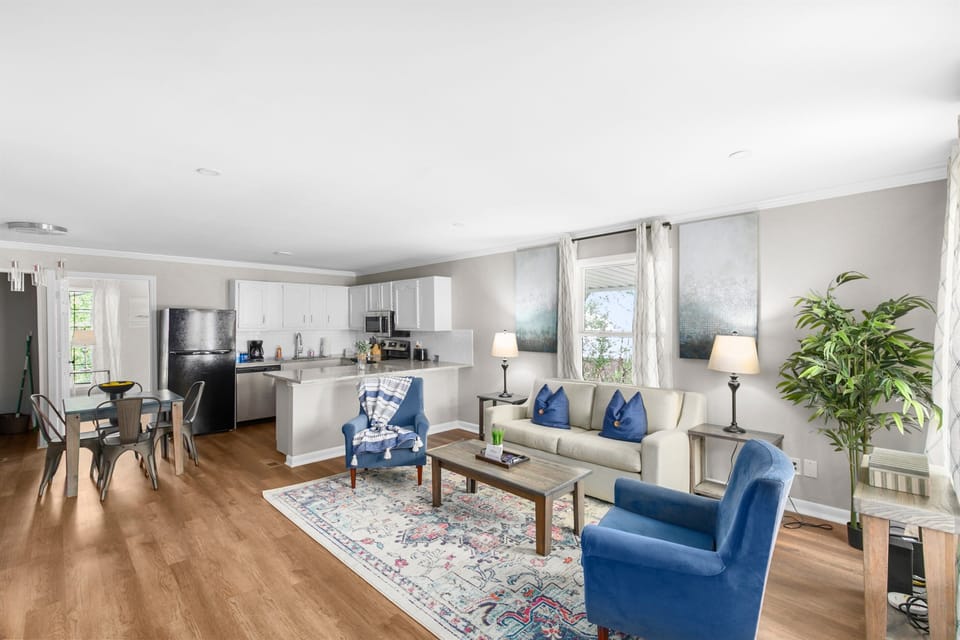 The open living area flows seamlessly into the kitchen and dining space, making it easy for everyone to stay connected whether you're cooking, eating, or relaxing.