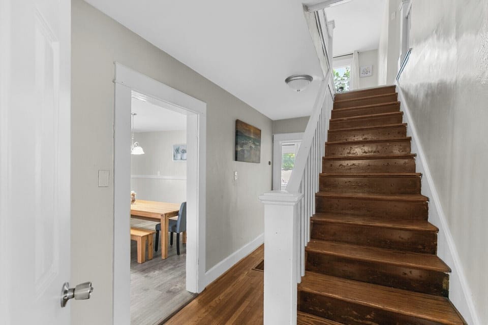 The staircase is conveniently located just off the main living area, providing easy access to the upstairs bedrooms and additional space.