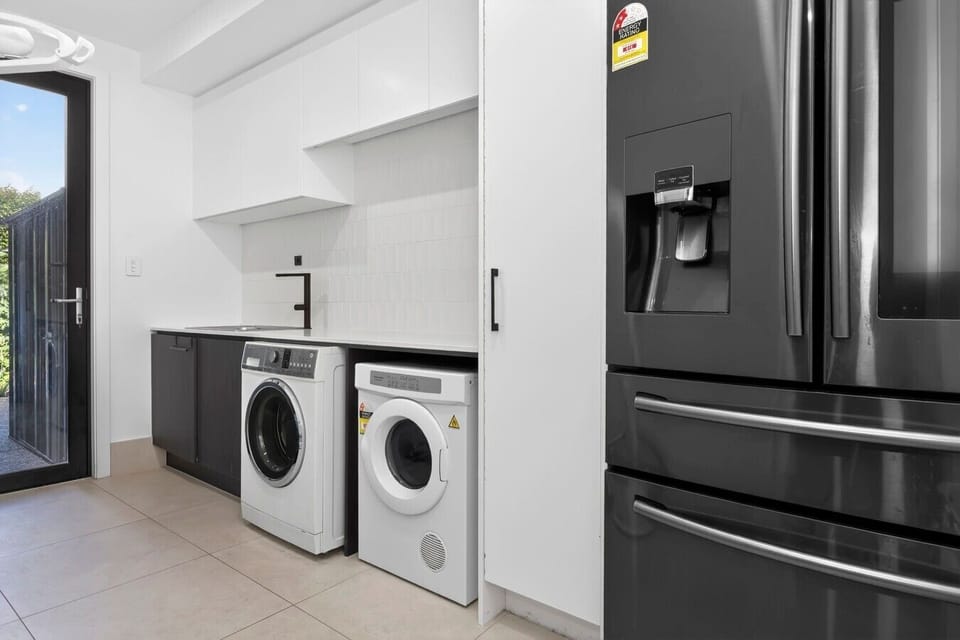 Laundry with washer, dryer & large fridge