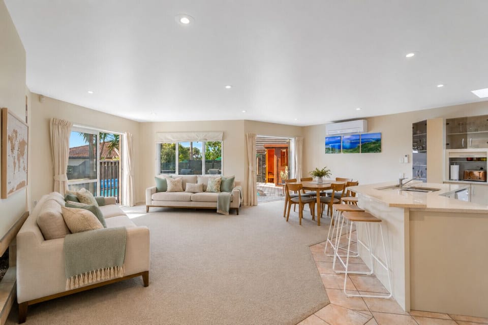 Open plan kitchen/lounge/dining area leading out to the pool and deck - note that the door are the pool fence.