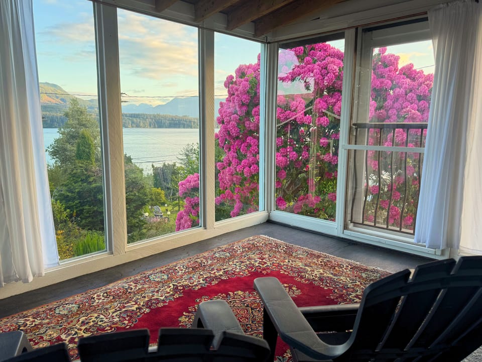 Sunroom with ocean, mountain, and garden views