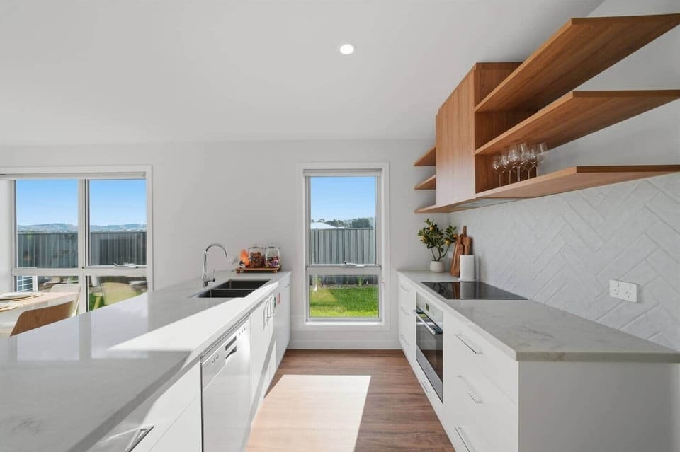 Stylish open kitchen with quality appliances in this Tasmania holiday accommodation.