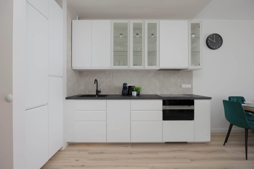 The sleek design of the kitchenette blending seamlessly with the living area.