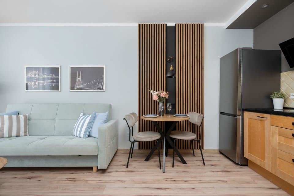 Bright living room with dining area, wooden accents and modern kitchenette