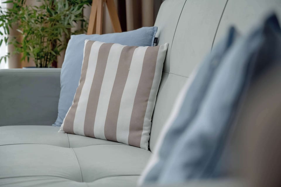 Decorative living room detail with striped cushions and elegant textures