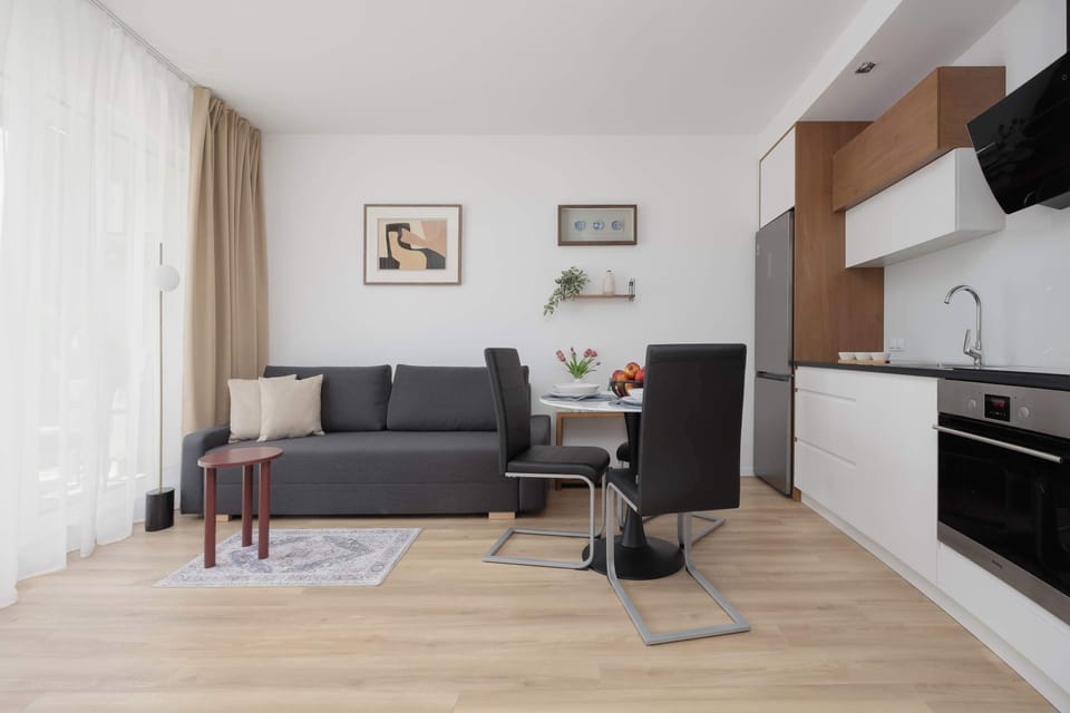 Cozy living room with compact kitchenette and modern wooden finishes