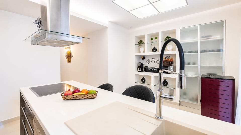 Modern kitchen and dining space featuring elegant finishes, premium amenities, and bright interiors 