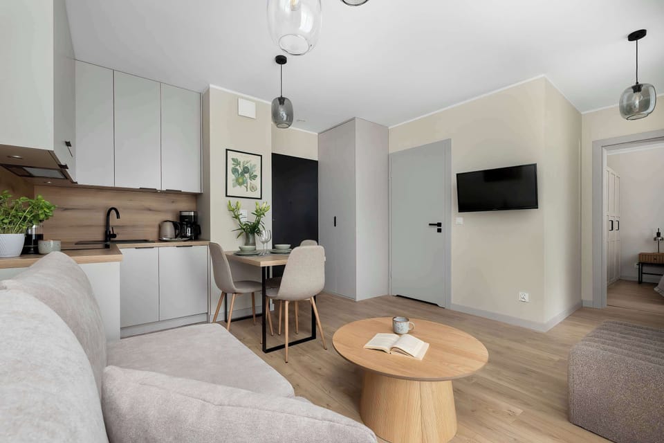 A modern living room with a comfortable seating area designed for relaxation and social time. The space feels bright, open, and tastefully furnished in a neutral style.