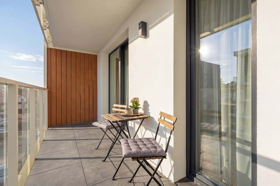 A small balcony area with seating, offering a pleasant outdoor spot. It is ideal for enjoying fresh air and relaxation.