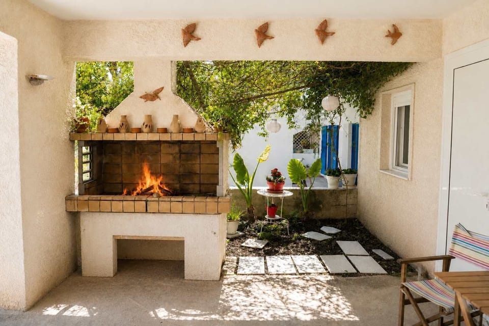 Sshaded outdoor BBQ area. The peaceful setting and cozy seating create the perfect atmosphere for enjoying warm summer afternoons and quiet evenings