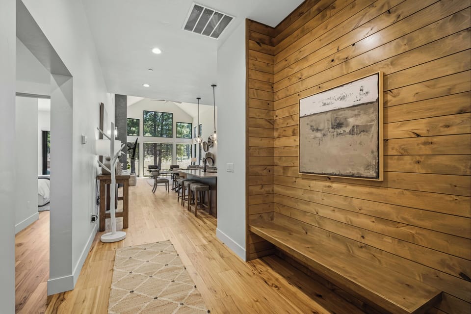 Step inside your modern mountain retreat where warm wood accents meet bright, open spaces. Natural light pours through soaring windows, inviting you to unwind and make yourself at home.