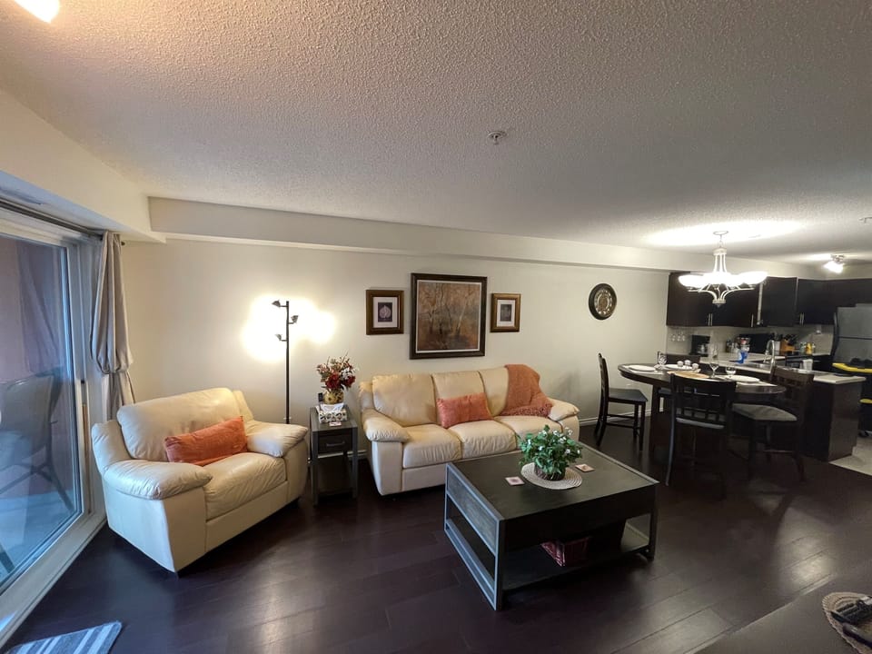 Cozy couch and open concept dining room.