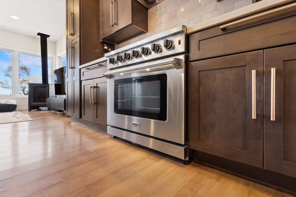 Modern kitchen w/ coffee maker, island seating for 4, & ocean views