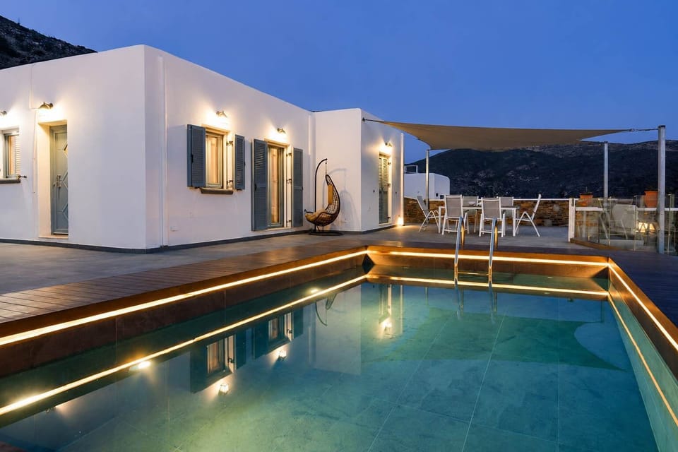 Private pool area beautifully illuminated at night, creating the perfect evening atmosphere.