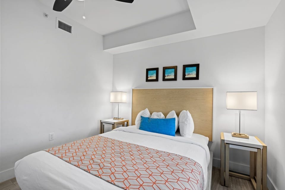 Enjoy a serene space with ample light, featuring cozy bedding and eye-catching artwork to enhance your stay.