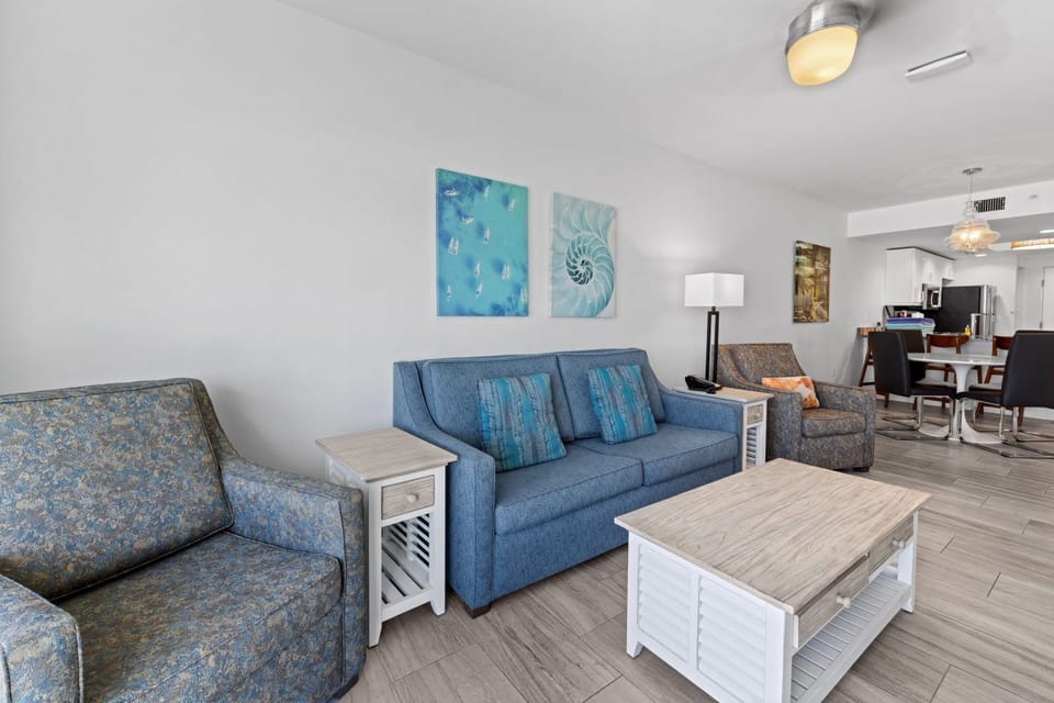 Relax in the cozy living area, adorned with ocean-inspired decor and comfortable seating for ultimate unwinding.