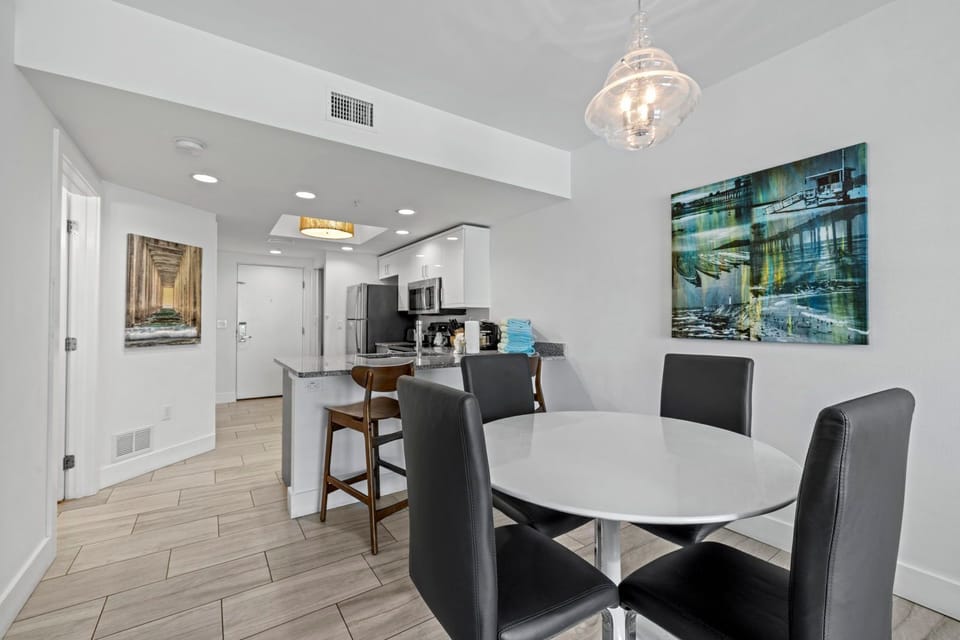 Gather around the modern dining table, just steps away from your fully equipped kitchen.