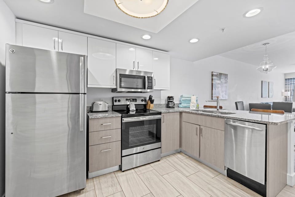 An inviting kitchen space awaits, complete with polished surfaces and ample storage.
