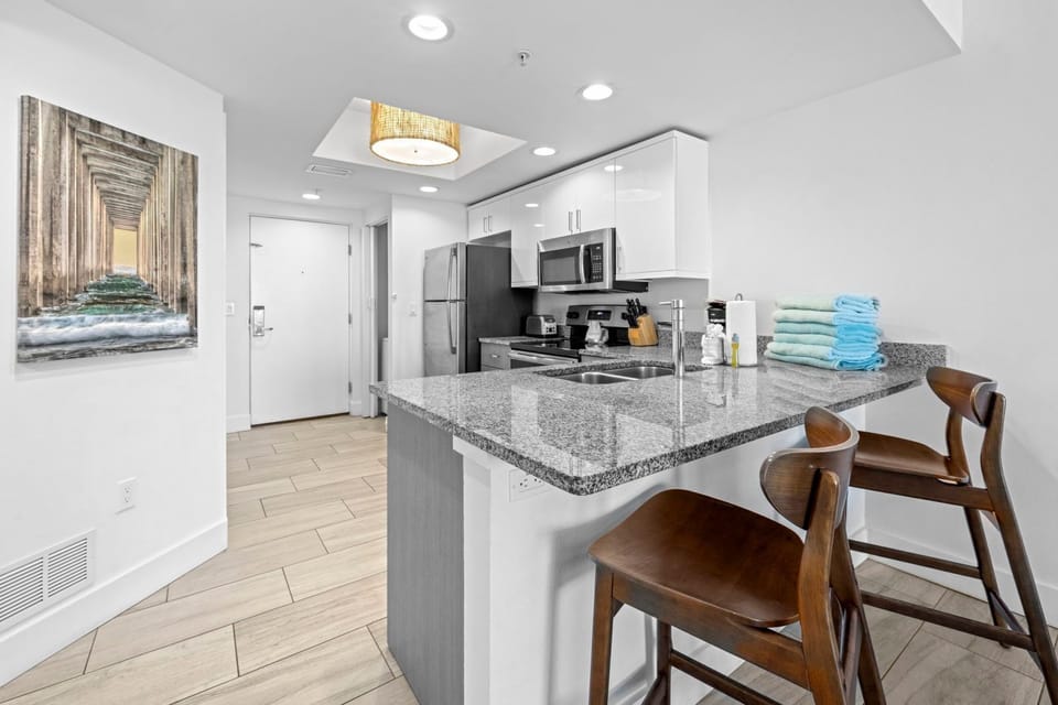 Cook up a feast in this sleek kitchen featuring stainless steel appliances and granite countertops.