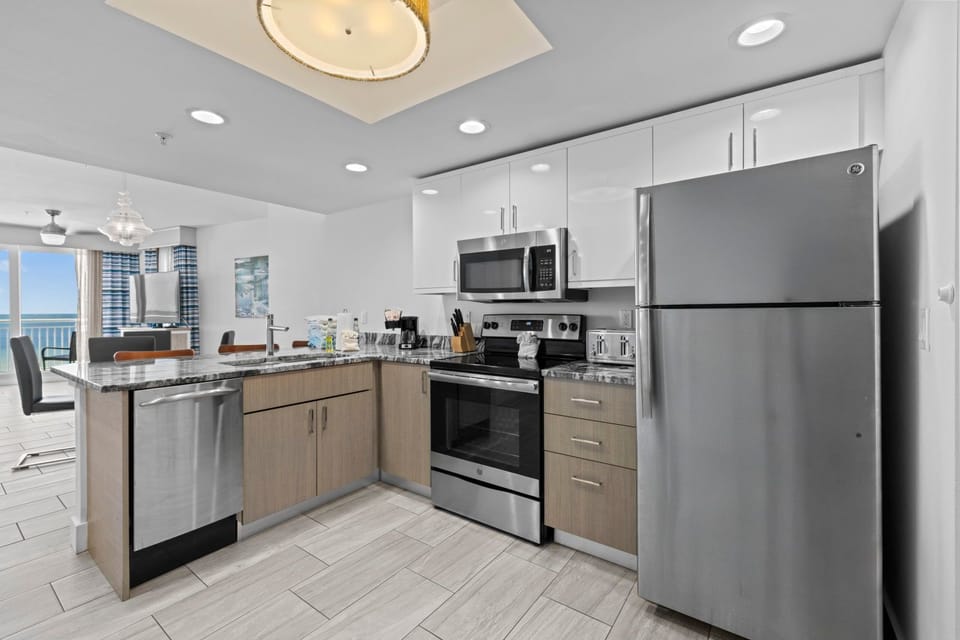 Cook your favorite meals in this modern kitchen featuring stainless steel appliances and sleek granite countertops.